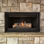 geist in beautiful stone surround for fireplace