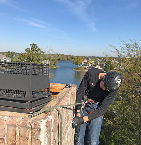 certified chimney tech repairing damaged chimney in fishers in 