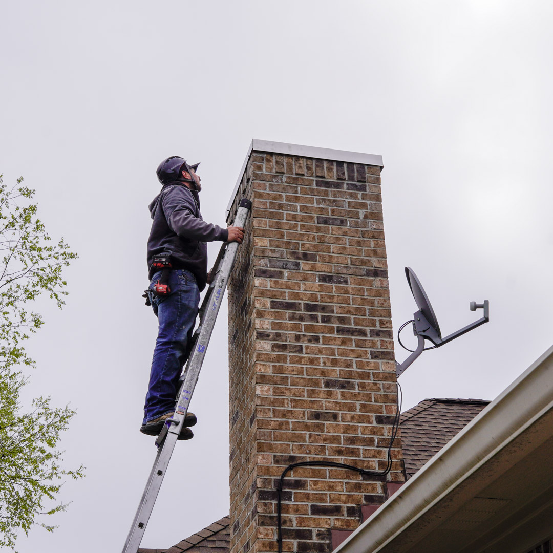 certified chimney tech repairing damaged chimney in zionsville IN