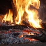 Fireplace with logs burning in a Fishers Indiana home