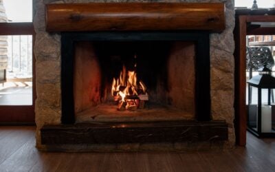 Stone fireplace with a roaring fire, illustrating correct fireplace damper use