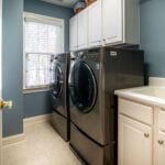 Clean organized laundry room with a dryer, representing professional dryer vent cleaning