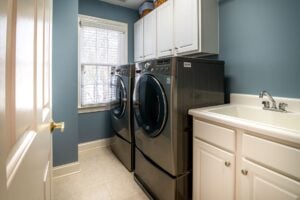 Clean organized laundry room with a dryer, representing professional dryer vent cleaning