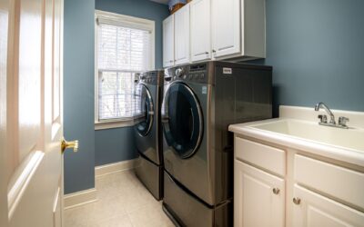 Clean organized laundry room with a dryer, representing professional dryer vent cleaning